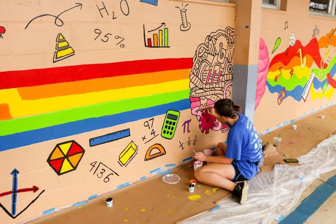 The finished left brain, right brain corridor mural pairing art and science